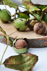 Wall Mural - Fresh walnuts with and without shells on a wooden surface. Walnuts, shelled and unshelled.
 Walnut background