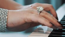 Beautiful Hands Of A Female Lady Piano Player Wearing A Gold Ring With A Diamond And A Bracelet

