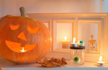 Wall Mural - halloween pumpkins with candles on wooden table