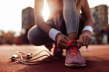 Runner tying jogging shoes