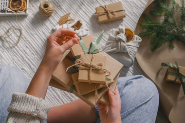 Wall Mural - christmas gift zero waste, eco friendly hand made box packaging gifts in kraft paper wooden table, e