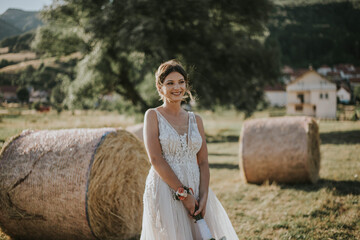 Sticker - Serene shot of a bride in a beautiful gown posing in a hayfield on her wedding day