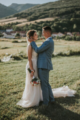 Wall Mural - Romantic shot of the beautiful bride and groom from Bosnia and Herzegovina in nature