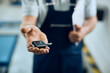 © Drazen - Close-up of mechanic holds key of repaired car in workshop.