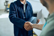 © Drazen - Close-up of maintenance engineer shakes hands with customer at car workshop.