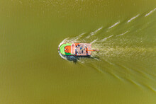 Aerial View Of A Tugboat Going Down The Guadalquivir River On The Way To The Marina In Seville, Andalusia, Spain.