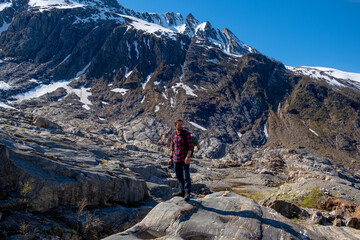 Fototapete - Man tourist with standing of great mountain Scandinavia nature