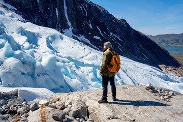 Fototapete - Man tourist with standing of great mountain Scandinavia nature