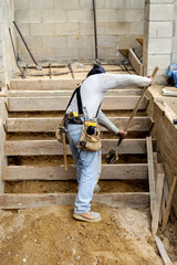 Wall Mural - Construction worker moving dirt under newly formed steps