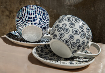 Wall Mural - Two ceramics cups with coaster on pink table cloth. Ceramic tableware, Beautiful arrangement, Copy space, Selective focus.