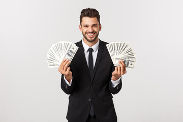 Wall Mural - Portrait of a satisfied young businessman holding bunch of money banknotes isolated over white background.