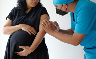 Wall Mural - doctor giving vaccine injection to pregnant woman