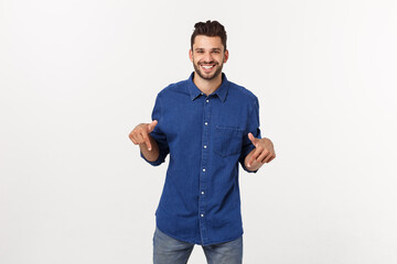 Wall Mural - Man pointing showing copy space isolated on white background. Casual handsome Caucasian young man.