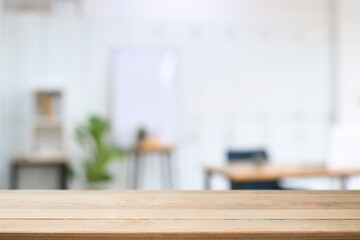 Empty wooden table with blurred living room background. For product display montage.