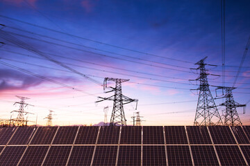 Wall Mural - Transmission towers and solar panels are clean energy concepts. Sunset background