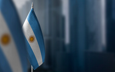 Wall Mural - Small flags of Argentina on a blurry background of the city