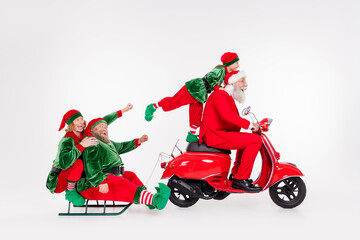 Poster - Portrait of attractive funny cheerful friends riding motor bike carrying sledge day holly jolly isolated over white color background