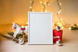 Fototapeta Tulipany - Portrait white picture frame mockup on table with boken lights and christmas decoration