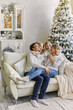 © Inna Vlasova - Happy young father mother and baby boy in christmas decorated studio