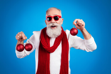 Sticker - Photo of pretty excited age gentleman wear sweater red eyewear smiling holding christmas decorations isolated blue color background