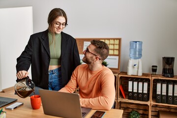 Sticker - Two caucasian business executives working and drinking coffee at the office.