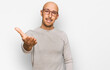 © Krakenimages.com - Bald man with beard wearing casual clothes and glasses smiling friendly offering handshake as greeting and welcoming. successful business.