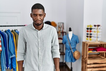 Wall Mural - Young african american man working as manager at retail boutique skeptic and nervous, frowning upset because of problem. negative person.