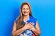 Middle age hispanic woman wearing casual clothes smiling with hands on chest with closed eyes and grateful gesture on face. health concept.