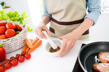 Wall Mural - Cropped photo of old woman grandmother hold hand mortar seasoning cook indoors inside house home kitchen