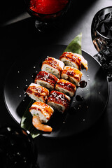 Wall Mural - Japanese sushi rolls with salmon, shrimp, smoked eel and red caviar