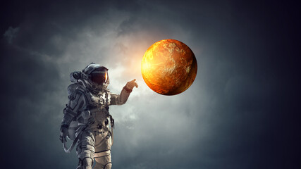 Wall Mural - astronaut walking on an unexplored planet