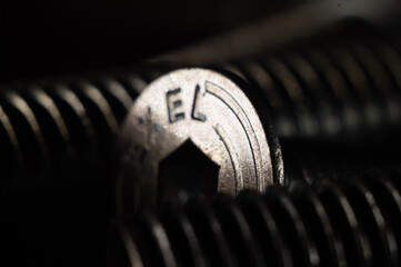 Sticker - Macro shot of a shiny new metal nail in a big set with a blurry background