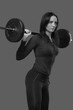 © zhagunov_a - young strong girl raises the barbell