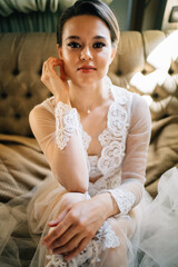 Wall Mural - a bride in a lace robe sitting in bed. morning before the wedding.