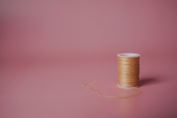 threads on a pink background