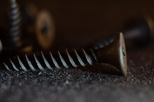 Macro Shot Of A Black Rusty Solid Nail On The Ground With A Blurry Background