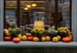 Showcase of  cafe is decorated in a rustic style with pumpkins and flowers. Beginning of festive season. Design of urban environment.