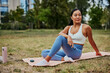 © bernardbodo - Asian sportswoman doing yoga in sporty outfit in park