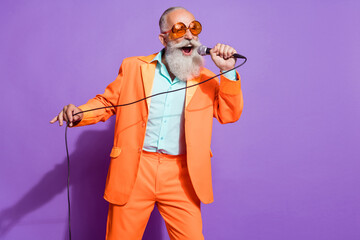 Photo of old funny funky cool man sing mic karaoke good mood enjoy isolated on purple color background