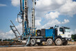 © Anoo - The drilling rig close-up is drilling a well against the background of the cloudy sky. Deep hole drilling. Geological exploration work. Mineral exploration. Powerful drill drills a well.