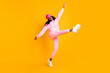 © deagreez - Full length photo portrait of dark skin girl kicking standing on one leg isolated on vivid yellow colored background