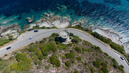 Wall Mural - Aerial view of the ruins of the round Genoese tower of l'Osse on the Cap Corse, Corsica, France - Remains of a medieval lookout in the curve of a road overlooking the Mediterranean Sea