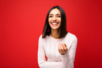 Wall Mural - Photo of young positive happy smiling beautiful woman with sincere emotions wearing stylish clothes isolated over background with copy space