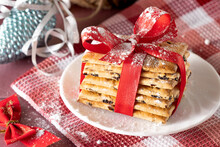 Christmas Cookies With A Red Ribbon On A White Plate