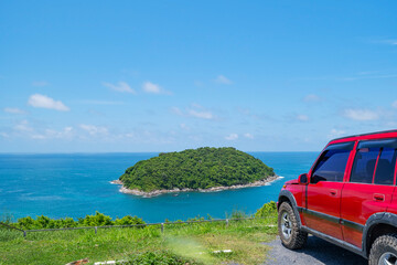 Red SUV 4x4 car on the mountain with Summer sea and small island background of free space for summer text and travel transportation background