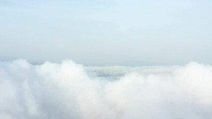 Wall Mural - View from above, drone point of view, stunning aerial video of a drone flying over some fluffy moving clouds. Copy space, natural background, video transition.