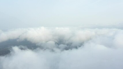 Wall Mural - View from above, drone point of view, stunning aerial video of a drone flying over some fluffy moving clouds. Copy space, natural background, video transition.