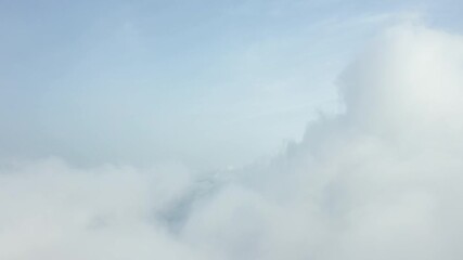 Wall Mural - View from above, drone point of view, stunning aerial video of a drone flying over some fluffy moving clouds. Copy space, natural background, video transition.