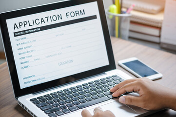 business man working on laptop computer and application Form Information for the searching job or fill out personal data for online web job the application form. Employment Concept.