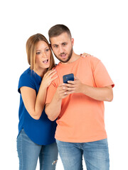 A young couple on a white background looking at the smartphone.